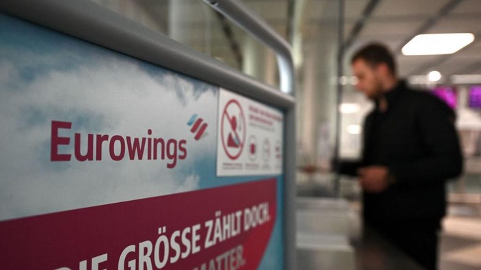 A passenger stands at a counter of the German airline Eurowings at the Franz-Josef-Strauss Airport in Munich, southern Germany, on October 17, 2022. - Pilots at the Lufthansa subsidiary Eurowings went on a three-day strike on October 17, 2022 to fight for better working conditions. (Photo by Christof STACHE / AFP) (Photo by CHRISTOF STACHE/AFP via Getty Images)