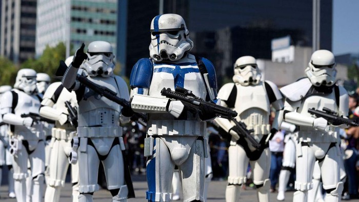 Fans of the Star Wars saga wear costumes during a parade called 