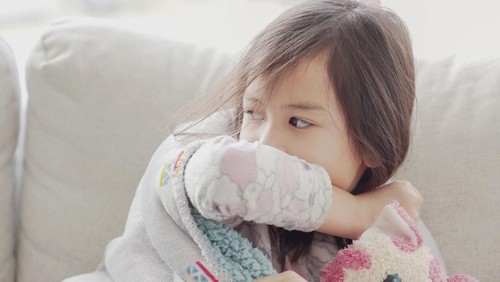 Mixed Asian sick girl coughing with her elbow at home, heath care concept