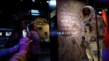 Pengunjung melihat artefak termasuk pakaian luar angkasa Neil Armstrong dan Modul Komando Columbia di pameran Apollo 11 di Museum Dirgantara dan Luar Angkasa Nasional Smithsonian.