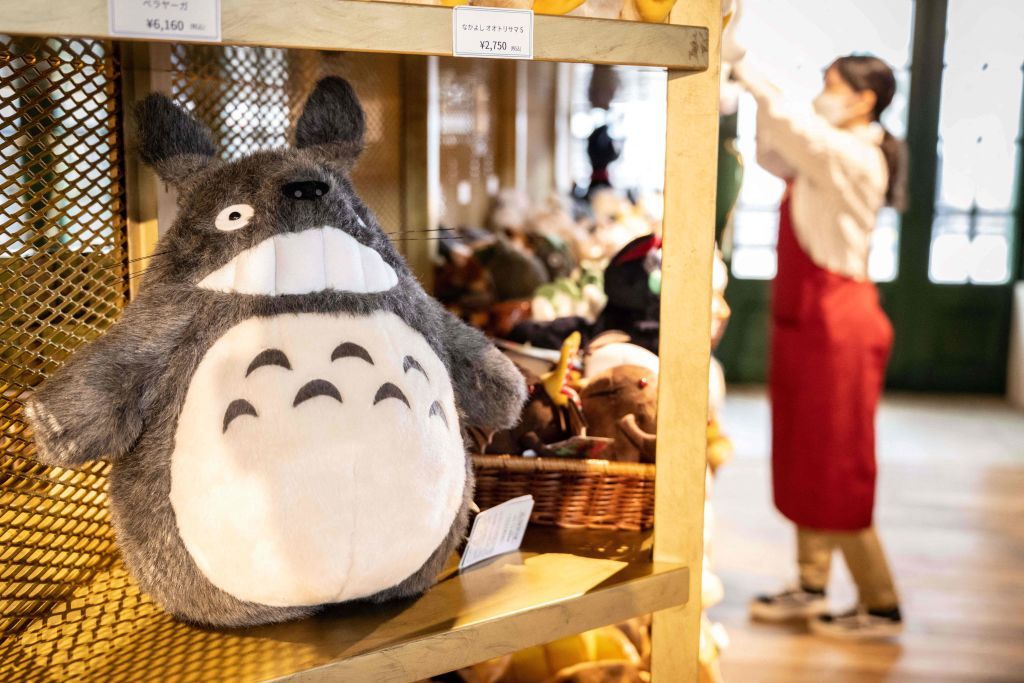 A soft toy of Ghibli caracter 'Totoro' is displayed in a shop at Ghibli's Grand Warehouse during a media tour of the new Ghibli Park in Nagakute, Aichi prefecture on October 12, 2022. - The media on October 12 got a sneak peek at the highly anticipated new theme park from Studio Ghibli, creator of beloved titles like 