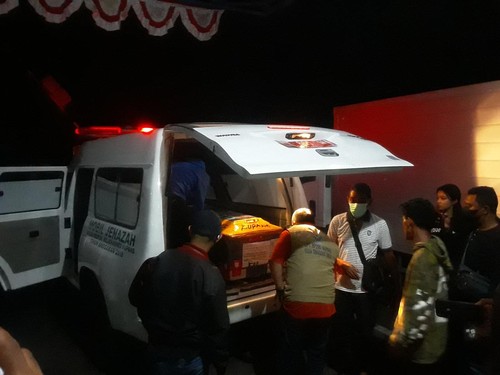Pihak keluarga bersama BP3MI NTT saat menurunkan peti jenazah Ririen Antonius, PMI perempuan asal Sikka NTT di Bandara El Tari Kupang, Selasa (18/10/2022)
