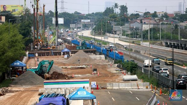 Sejumlah kendaraan melintas di samping proyek penanganan banjir di KM 8 Tol Pondok Aren-Serpong, Tangerang Selatan, Banten, Selasa (18/10/2022). Kementerian PUPR mengatakan tengah melakukan upaya untuk menangani banjir di Jalan Tol Pondok Aren-Serpong KM 8+500. (CNBC Indonesia/ Muhammad Sabki)