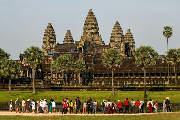 This picture taken on April 7, 2022 shows tourists visiting the Angkor Wat temple complex, a UNESCO World Heritage Site, in Siem Reap province. - - TO GO WITH Cambodia-economy-tourism, FOCUS by Suy SE (Photo by TANG CHHIN Sothy / AFP) / TO GO WITH Cambodia-economy-tourism, FOCUS by Suy SE (Photo by TANG CHHIN SOTHY/AFP via Getty Images)