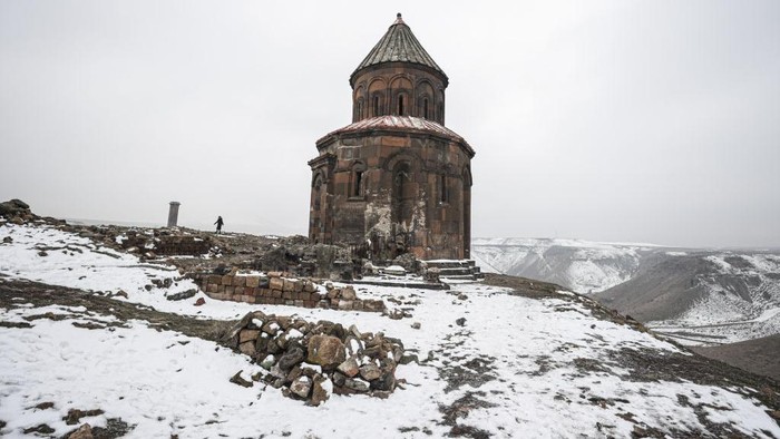 KARS, TURKEY - DECEMBER 17: A view of Ani ancient city which passengers of Turkey's Touristic Eastern Express train can visit in Kars, Turkey on December 17, 2021. Turkey's Touristic Eastern Express train line resumes as of Wednesday, Dec. 15, after being suspended due to coronavirus restrictions in the country. The Touristic Eastern Express offers passengers an unforgettable 25-hour journey with picturesque views all along the route.It was put into service by the Turkish State Railways (TCDD) in 2019 in order to meet the increasing demand as well as contribute to domestic tourism in the country.The eastbound train runs 1,310 kilometers (814 miles) between the capital Ankara and Kars, passing by provinces like Kirikkale, Sivas, Erzincan, and Erzurum.When the train arrives at its last stop, Kars, passengers will have the opportunity to see historic places such as the Kars Castle, the ancient city of Ani, which was added to the UNESCO World Heritage List in 2016, and the Caucasian Front War History. (Photo by Metin Aktas/Anadolu Agency via Getty Images)