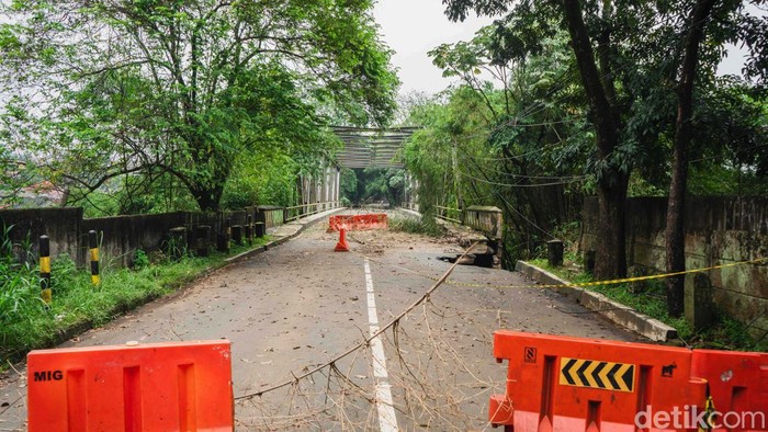 Tebing longsor di ujung jembatan Sungai Cisadane di Jl Darul Quran, Kota Bogor, hingga kini belum diperbaiki. Begini kondisi terkininya.