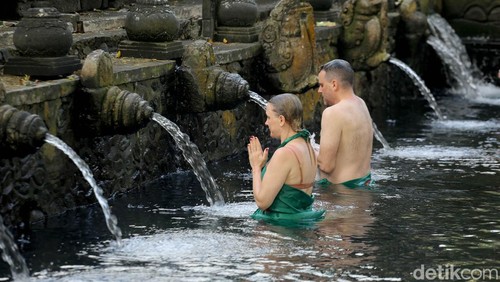 Ilustrasi Melukat di Pura Tirta Empul, Bali.