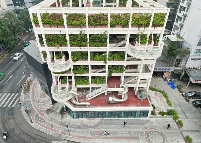 CHENGDU, CHINA - OCTOBER 19: A newly renovated office building with a slide is seen on October 19, 2022 in Chengdu, Sichuan Province of China. A total of 11 slides spanning up to 3 floors were attached to the old office building. (Photo by Zhang Lang/China News Service via Getty Images)