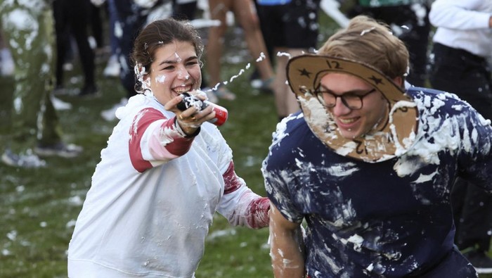 Students from St Andrews University are covered in foam as they take part in the traditional 