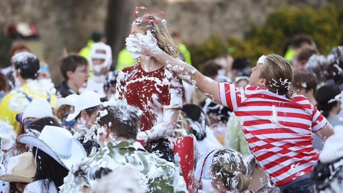 Students from St Andrews University are covered in foam as they take part in the traditional 