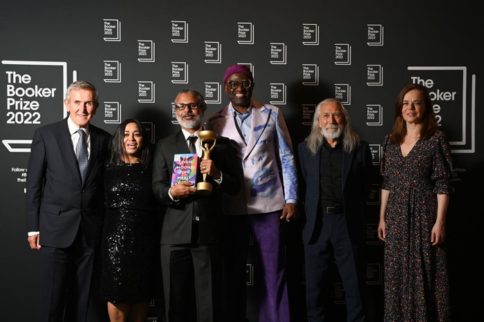 Tugas Baru Camilla, Umumkan Pemenang Booker Prize for Fiction 2022 LONDON, ENGLAND - OCTOBER 17: Camilla, Queen Consort presents winner Shehan Karunatilaka for The Seven Moons of Maali Almeida with the Booker Prize for Fiction 2022 award at the Roundhouse, on October 17, 2022, in London, England. (Photo by Toby Melville - WPA Pool/Getty Images)