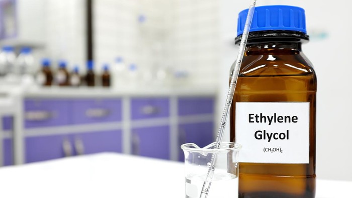 Selective focus of ethylene glycol liquid chemical compound in dark glass bottle inside a chemistry laboratory with copy space.