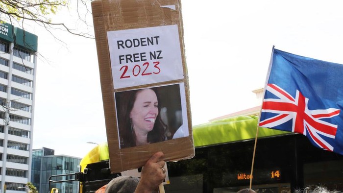 1434871128 WELLINGTON, NEW ZEALAND - OCTOBER 20: A placard targeting Jacinda Ardern is held aloft at a Groundswell protest against government regulation and climate change policies on October 20, 2022 in Wellington, New Zealand. The New Zealand government announced plans on 11 October aimed at reducing agricultural emissions, including proposed taxes on farmers. (Photo by Lynn Grieveson/Getty Images)