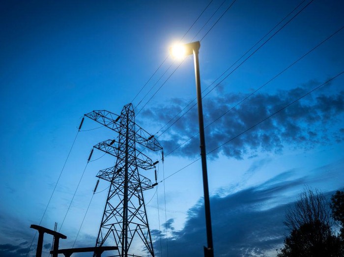 MANCHESTER, ENGLAND - OCTOBER 19: Night time falls behind electricity pylons and a sub station on October 19, 2022 in Manchester, England. The British utility company, National Grid, said this week that UK households may face power cuts this winter for up to three hours at a time, if gas supplies run low. The UK relies heavily on gas to produce electricity, and gas supplies to Europe have been severely disrupted by the fallout from Russias invasion of Ukraine (Photo by Christopher Furlong/Getty Images)
