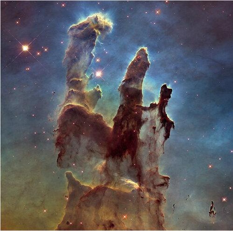 This image released by NASA on Wednesday, Oct. 19, 2022, shows the Pillars of Creation, captured by the James Webb Space Telescope in near-infrared-light view. (NASA, ESA, CSA, STScI via AP)