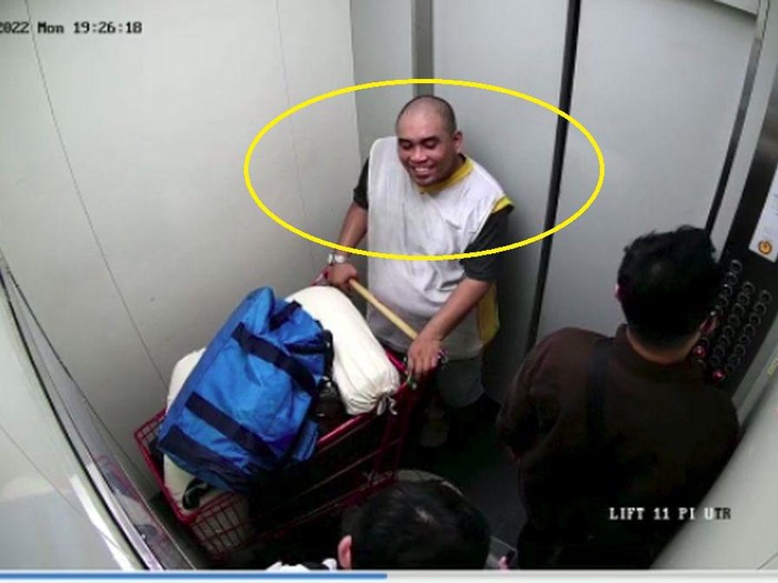 Tersangka Rudolf saat tertangkap kamera CCTV lift apartemen mendorong jenazah dibungkus plastik dengan troli di kawasan Jakarta Timur