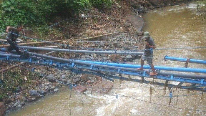 Perbaikan pipa distribusi Perumda TAB di sumber air Dedari, Kecamatan Marga, yang rusak diterjang banjir bandang.