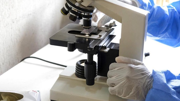 Medical attendants walk outside the Ebola isolation section of Mubende Regional Referral Hospital, in Mubende, Uganda Thursday, Sept. 29, 2022. In this remote Ugandan community facing its first Ebola outbreak, testing trouble has added to the challenges with symptoms of the Sudan strain of Ebola now circulating being similar to malaria, underscoring the pitfalls health workers face in their response. (AP Photo/Hajarah Nalwadda)