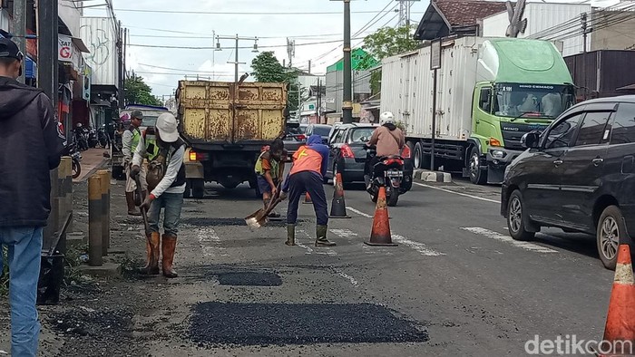 Petugas PPK Jalan menambal lubang di jalan Jogja-Solo Kecamatan Delanggu, Sabtu (22/10/2022).