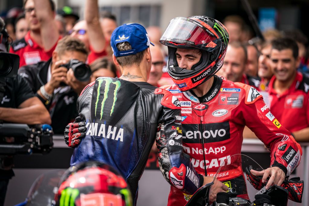 SPIELBERG, AUSTRIA - AUGUST 21: Fabio Quartararo of France and Monster Energy Yamaha MotoGP and Francesco Bagnaia of Italy and Ducati Lenovo Team shake hands after the race at parc ferme during the race of the CryptoDATA MotoGP of Austria at Red Bull Ring on August 21, 2022 in Spielberg, Austria. (Photo by Steve Wobser/Getty Images)