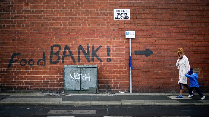 LEEDS, ENGLAND - OCTOBER 21: A sign painted on the side of a house directs people to a local food bank on October 21, 2022 in Leeds, England. A report from the Office for National Statistics (ONS) published earlier this week showed consumer prices index rising to 10.1% in September, with food and drink rising at a rate of 15%, the largest jump in decades and forcing many people to use charity food banks. (Photo by Christopher Furlong/Getty Images)