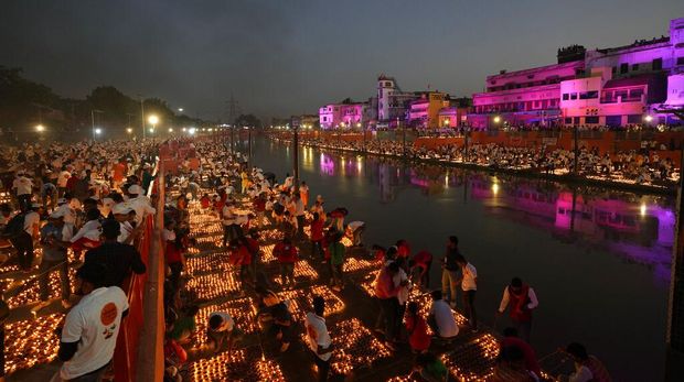 People light lamps on the banks of the river Saryu in Ayodhya, India, Sunday, Oct. 23, 2022. Over 15,00,000 earthen lamps were lit along the banks of the Saryu River, as millions of people across Asia celebrate Diwali, the Hindu festival of lights. (AP Photo/Rajesh Kumar Singh)