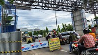 Seorang petugas memberikan arahan kepada pengendara agar jalanan tidak tersendat akibat proyek tersebut.