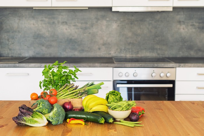 Fresh farm fruit and vegetables at the kitchen counter
