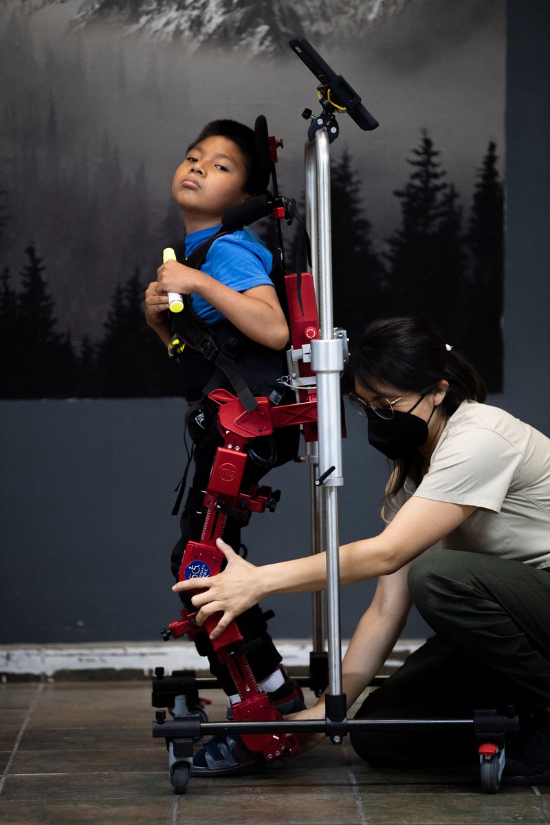 David Zabala (C), an 8-year-old boy with cerebral palsy, is assisted by physical therapists during a rehabilitation session with the robotic exoskeleton Atlas 2030 at the Association for People with Cerebral Palsy (APAC) in Mexico City on October 18, 2022. - The Atlas 2030 pediatric exoskeleton, which won its creator, Spanish Elena García Armada, the 2022 European Inventor award, has been in use in Mexico since October, thanks to the efforts of the Association for People with Cerebral Palsy (APAC), a private organisation founded in 1970. (Photo by CLAUDIO CRUZ / AFP) (Photo by CLAUDIO CRUZ/AFP via Getty Images)