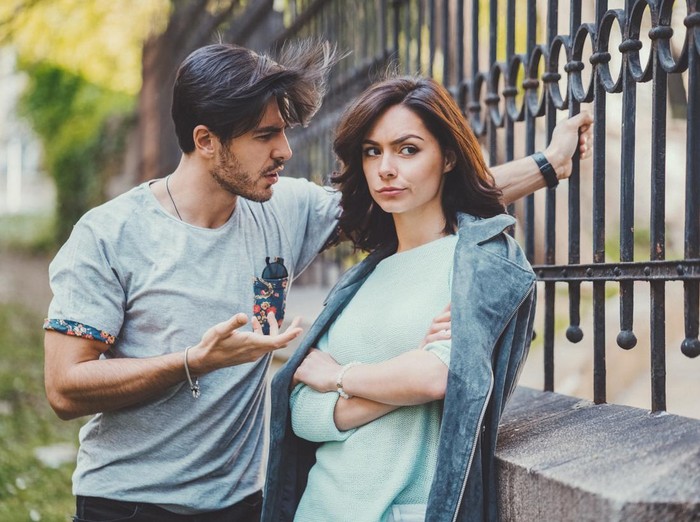 Unhappy couple outside talking about problems