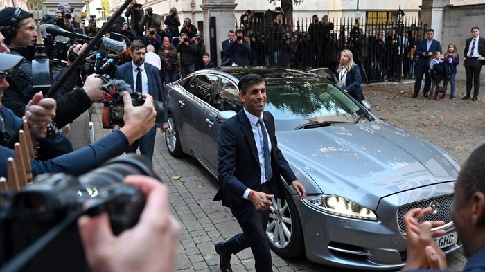 New Conservative Party leader and incoming prime minister Rishi Sunak (C) reacts as he his greeted by colleagues upon his arrival at Conservative Party Headquarters in central London having been announced as the winner of the Conservative Party leadership contest, on October 24, 2022. - Britains next prime minister, former finance chief Rishi Sunak, inherits a UK economy that was headed for recession even before the recent turmoil triggered by Liz Truss. (Photo by JUSTIN TALLIS / AFP) (Photo by JUSTIN TALLIS/AFP via Getty Images)