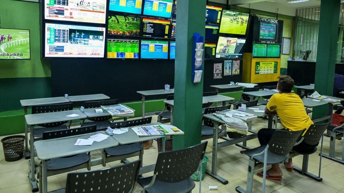 A man watch of horse races conducted overseas, at a betting shop in Colombo on October 24, 2022, hours after the government announced up to 150 percent increase in taxes for casinos and gambling in the crisis-hit country facing its worst economic crisis. (Photo by Ishara S. KODIKARA / AFP) (Photo by ISHARA S. KODIKARA/AFP via Getty Images)