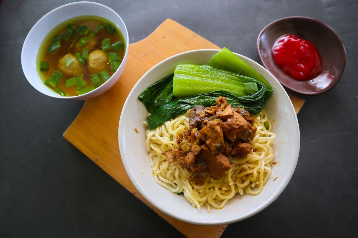 mie ayam or noodles chicken is traditional food from indonesia, asia made from noodle, chicken, chicken broth, spinach, sometimes with meatball.