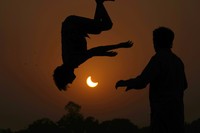 The moon blocks part of the sun during a partial solar eclipse in downtown Beirut, Lebanon, Tuesday, Oct. 25, 2022. (AP Photo/Hassan Ammar)