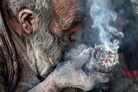 Amou Haji (uncle Haji) smokes from his waterpipe as he sits on the ground on the outskirts of the village of Dezhgah in the Dehram district of the southwestern Iranian Fars province, on December 28, 2018. - Believed to be the worlds dirtiest man, villagers say that Hajis leather-like skin hasnt touched soap and water for more than sixty years. They believe that he decided to live in isolation after suffering from an emotional setback in his youth. (Photo by - / AFP) (Photo by -/AFP via Getty Images)