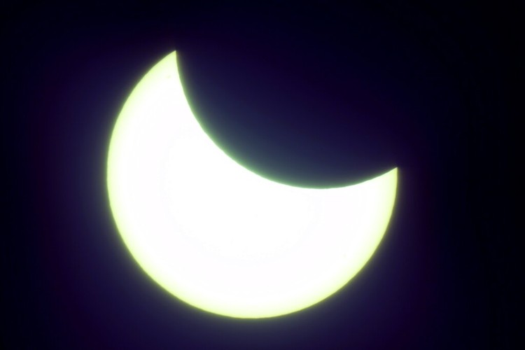 The moon covering part of the sun, during a partial solar eclipse at the monument of Soviet Marshal Georgy Zhukov in Moscow, Russia, Tuesday, Oct. 25, 2022. (AP Photo/Victor Berezkin)