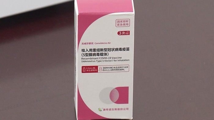 In this photo taken from video released by Shanghai Media Group, a medical worker hands over aerosolised COVID vaccine developed by Chinese biopharmaceutical company CanSino Biologics Inc. in Shanghai on Wednesday, Oct. 26, 2022. The Chinese city of Shanghai started administering the inhalable COVID-19 vaccine on Wednesday in what appears to be a world first. (Shanghai Media Group via AP)