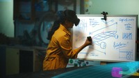 A woman sitting at a desk works on virtual screens using Metas Quest Pro device, which the company is pitching as a productivity tool, in this undated handout picture. Meta/Handout via REUTERS    THIS IMAGE HAS BEEN SUPPLIED BY A THIRD PARTY. REFILE - ADDING RESTRICTION NO RESALES. NO ARCHIVES.