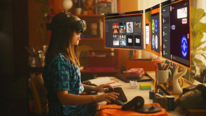 A woman sitting at a desk works on virtual screens using Metas Quest Pro device, which the company is pitching as a productivity tool, in this undated handout picture. Meta/Handout via REUTERS    THIS IMAGE HAS BEEN SUPPLIED BY A THIRD PARTY. REFILE - ADDING RESTRICTION NO RESALES. NO ARCHIVES.