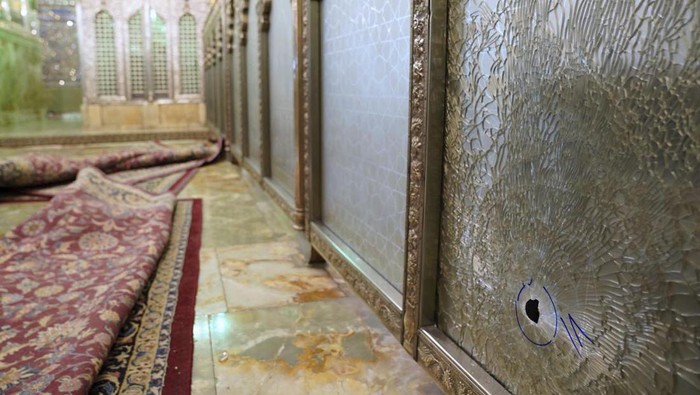A bullet hole is seen in a broken glass of the Shah Cheragh shrine in the southern city of Shiraz, Iran, Wednesday, Oct. 26, 2022. Gunmen attacked a major Shiite holy site in Iran on Wednesday, killing at least 15 people and wounding dozens. The attack came as protesters elsewhere in Iran marked a symbolic 40 days since a womans death in custody ignited the biggest anti-government movement in over a decade. (Iranian Students News Agency, ISNA via AP)