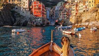 Kamu bisa menikmati sekotak pizza khas Italia dengan bir dingin sambil berlayar di atas perahu kayu yang menyusuri Cinque Terre. Foto: Instagram @cinqueterretrip