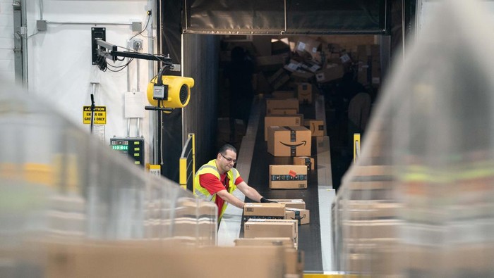 APPLING, GA - OCTOBER 27: A worker drives past  a cardboard dragon at the Amazon AGS5 sort facility on October 27, 2022 in Appling, Georgia. Amazon, the leading United States retail e-commerce company is preparing for the busy winter holiday season and plans to hire 150,000 full-time, seasonal and part-time workers to fulfill orders. (Photo by Sean Rayford/Getty Images)