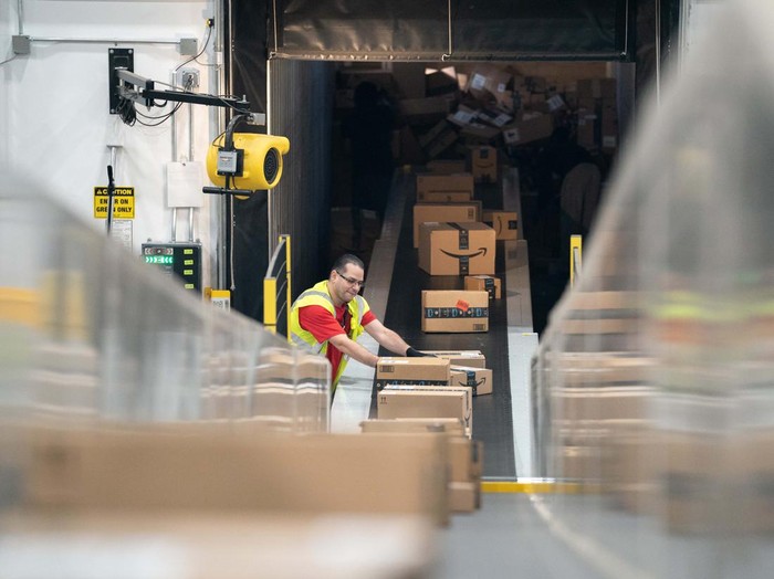 APPLING, GA - OCTOBER 27: A worker drives past  a cardboard dragon at the Amazon AGS5 sort facility on October 27, 2022 in Appling, Georgia. Amazon, the leading United States retail e-commerce company is preparing for the busy winter holiday season and plans to hire 150,000 full-time, seasonal and part-time workers to fulfill orders. (Photo by Sean Rayford/Getty Images)