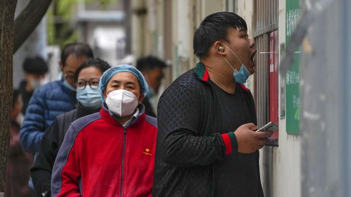 Residents wearing face masks wait in line to get their routine COVID-19 throat swabs at a coronavirus testing site in Beijing, Thursday, Oct. 27, 2022. Chinas ruling Communist Party has so far shown no sign of easing the zero-COVID policy, moving quickly to restrict travel and impose lockdowns when even just a few cases are discovered. (AP Photo/Andy Wong)
