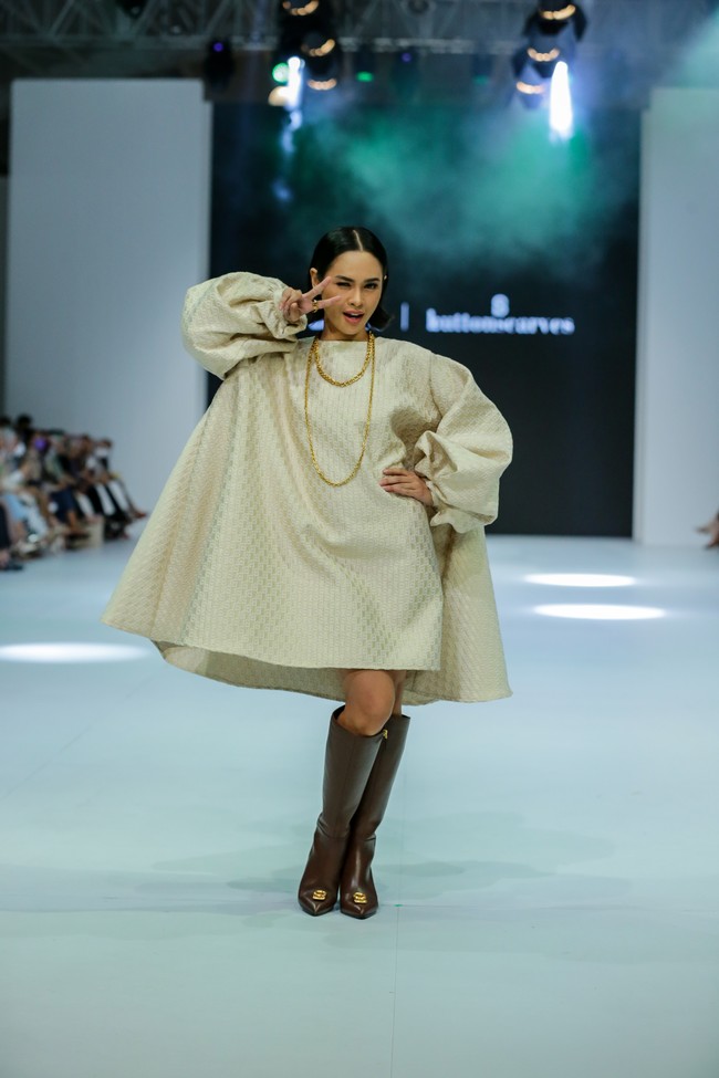Inilah penampilan Andien saat memeragakan mini dress bersiluet A dari Buttonscarves di panggung JFW, Jumat (28/10/2022). Gayanya dilengkapi dengan sepasang boots tinggi yang stylish. (Foto: Dachri Megantara/Jakarta Fashion Week)
