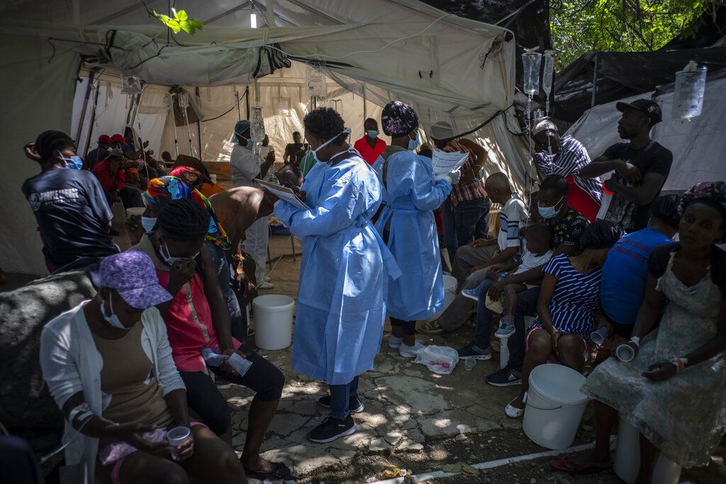 Medical personnel attend patients with cholera symptoms at a clinic run by Doctors Without Borders in Port-au-Prince, Haiti, Thursday, Oct. 27, 2022. For the first time in three years, people in Haiti have been dying of cholera, raising concerns about a potentially fast-spreading scenario and reviving memories of an epidemic that killed nearly 10,000 people a decade ago. (AP Photo/Ramon Espinosa)