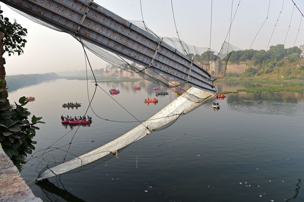 Rescue personnel conduct search operations after a bridge across the river Machchhu collapsed at Morbi in India's Gujarat state on October 31, 2022. - At least 130 people were killed in India after a colonial-era pedestrian bridge collapsed, sending scores of people tumbling into the river below, police said on October 31. (Photo by Sam PANTHAKY / AFP) (Photo by SAM PANTHAKY/AFP via Getty Images)