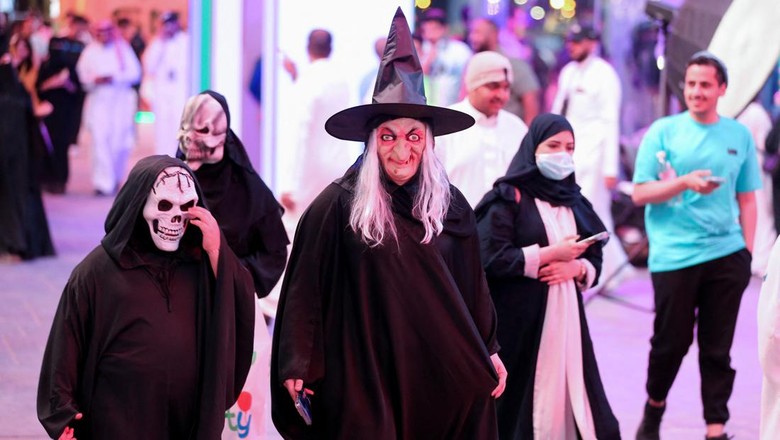 A Saudi man takes a photo with people dressed in costumes to celebrate Halloween during Scary Weekend Event at Boulevard, during Riyadh Season in Riyadh, Saudi Arabia, October 28, 2022. REUTERS/Ahmed Yosri