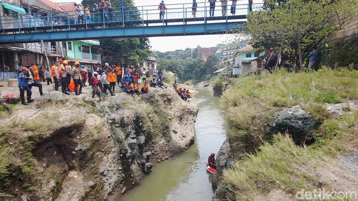 Tim SAR gabungan memasang jaring hingga menyelam untuk mencari bocah laki-laki yang hilang terbawa arus saat berenang di Sungai Ciliwung Kota Bogor. (M Sholihin/detikcom)