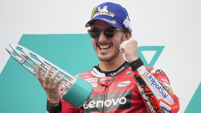 Italian rider Francesco Bagnaia of the Ducati Lenovo Team celebrates his winning of the MotoGP during the awards ceremony in the Malaysia Motorcycle Grand Prix in Sepang International Circuit, Sunday, Oct. 23, 2022. (AP Photo/Vincent Thian)